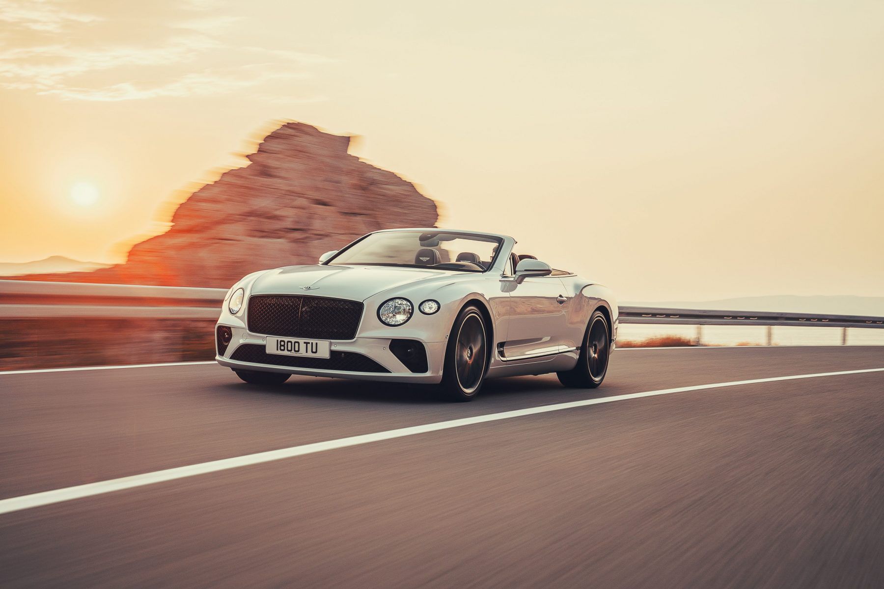 Bentley Continental GT Convertible driving on a road